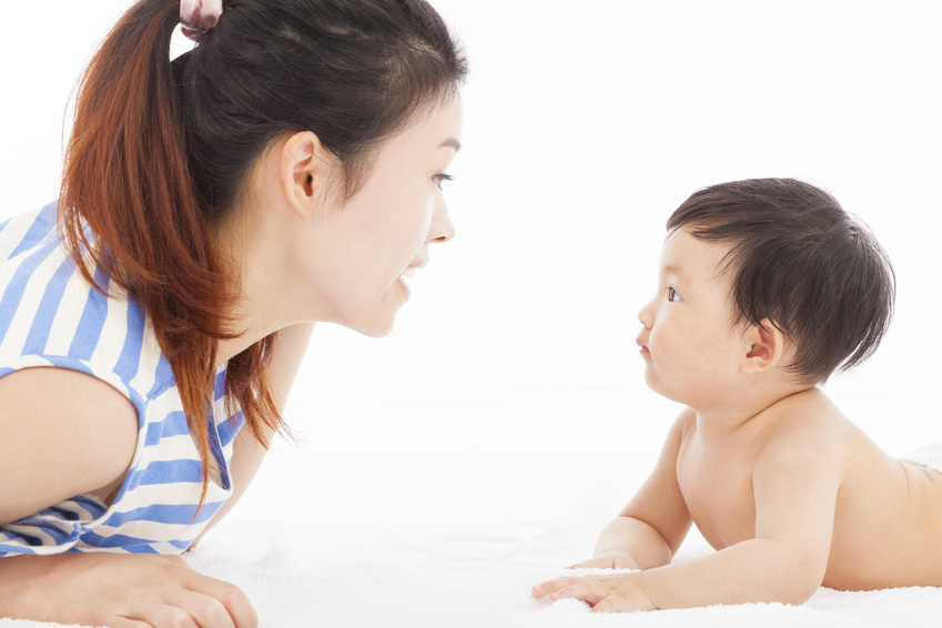 Happy mother talking with baby boy