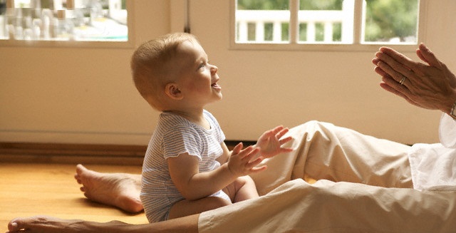 Infant Playing with Mother --- Image by © Jerry Tobias/CORBIS